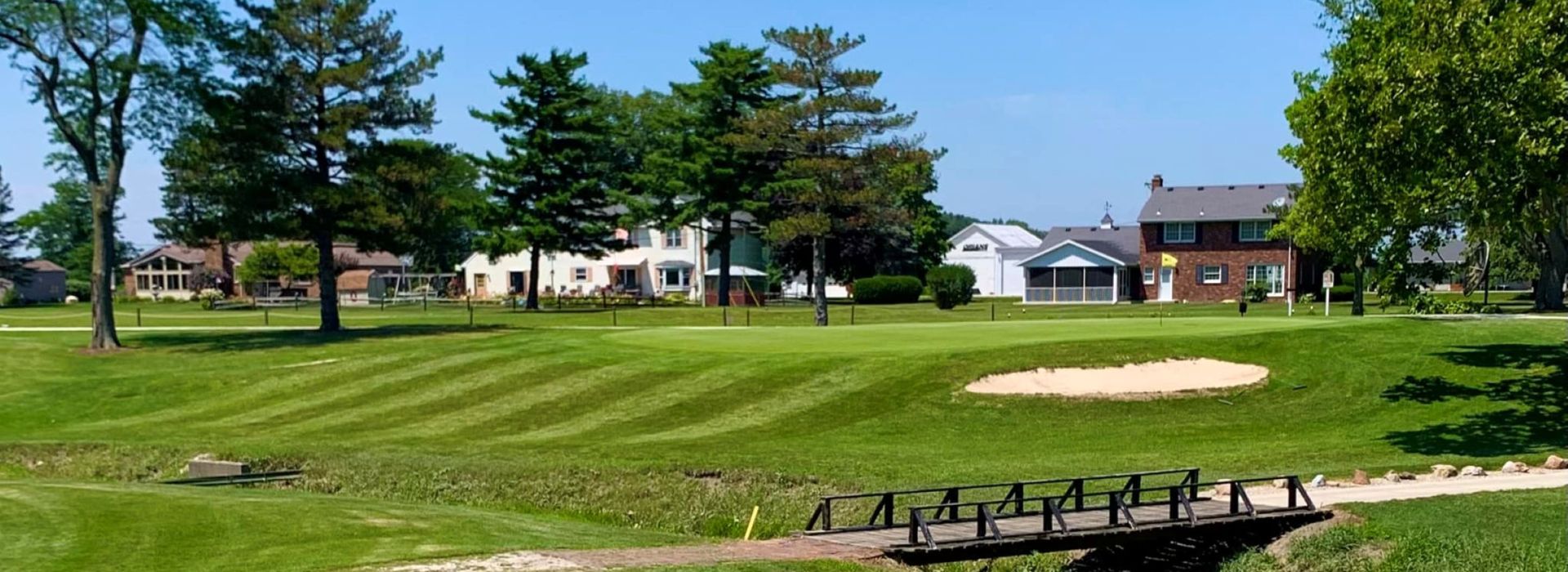 Cart path and manicured greens of golf course